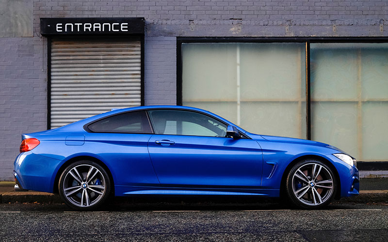 Blue business coupe parked